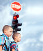 Two young boys waiting at a stoplight Two young boys waiting at a stoplight