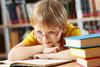 Boy reading in the library Boy reading in the library