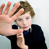 Young boy shielding face from a bully Young boy shielding face from a bully
