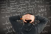 Man staring at a chalkboard of questions: who? what? when? Man staring at a chalkboard of questions: who? what? when?