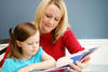 Teacher reading book with young student Teacher reading book with young student
