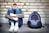 boy sitting against a wall with his head in his hands boy sitting against a wall with his head in his hands