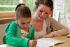 student and teacher working on a paper student and teacher working on a paper