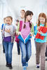 students walking in the hallway at school students walking in the hallway at school